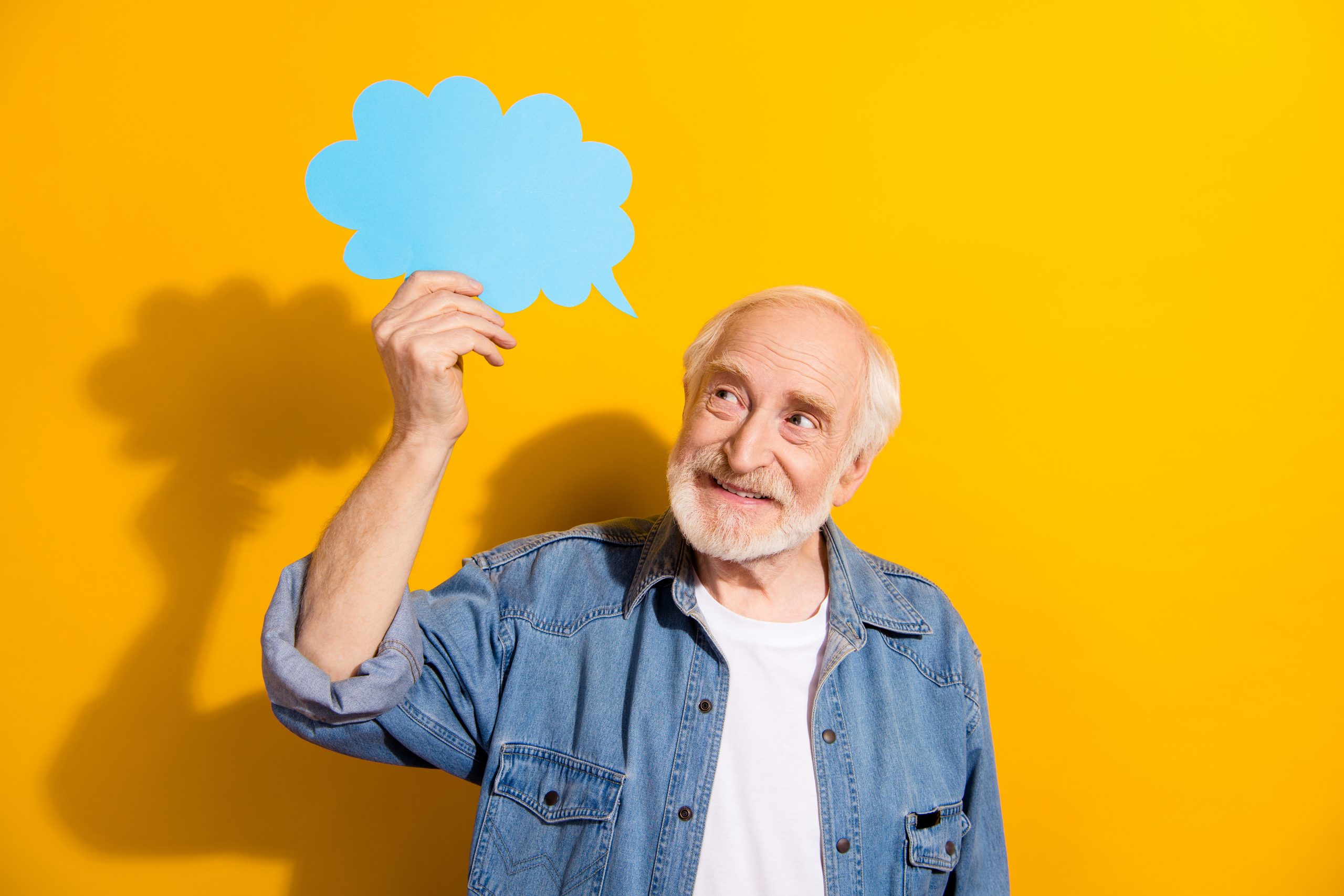 Portrait of optimistic handsome grey beard old man hold bubble wear shirt isolated on orange background